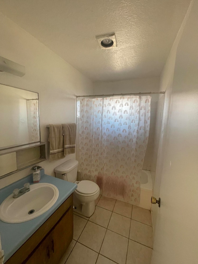 full bathroom with toilet, tile floors, shower / tub combo with curtain, a textured ceiling, and vanity