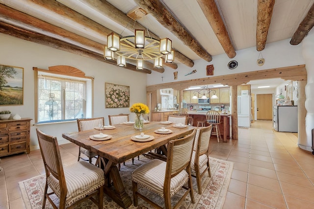112 Ten Pines Rd, Torreon, NM 87061 - dining space featuring light tile patterned flooring, beam ceiling, and a chandelier