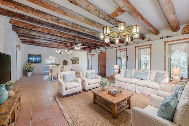 living area featuring beam ceiling, ceiling fan, and light tile patterned floors