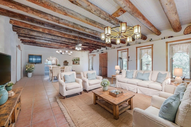 112 Ten Pines Rd, Torreon, NM 87061 - living room featuring a chandelier, beamed ceiling, light tile patterned flooring, and a ceiling fan