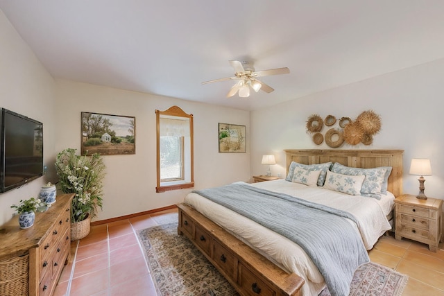 bedroom with baseboards, a ceiling fan, and light tile patterned flooring