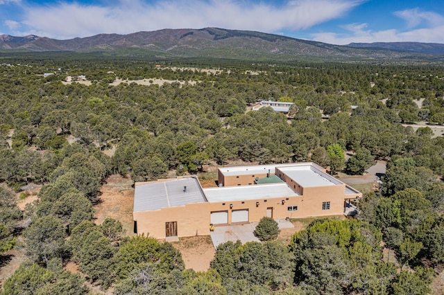 bird's eye view with a mountain view and a view of trees