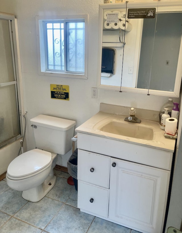 full bathroom with vanity, combined bath / shower with glass door, toilet, and tile patterned flooring