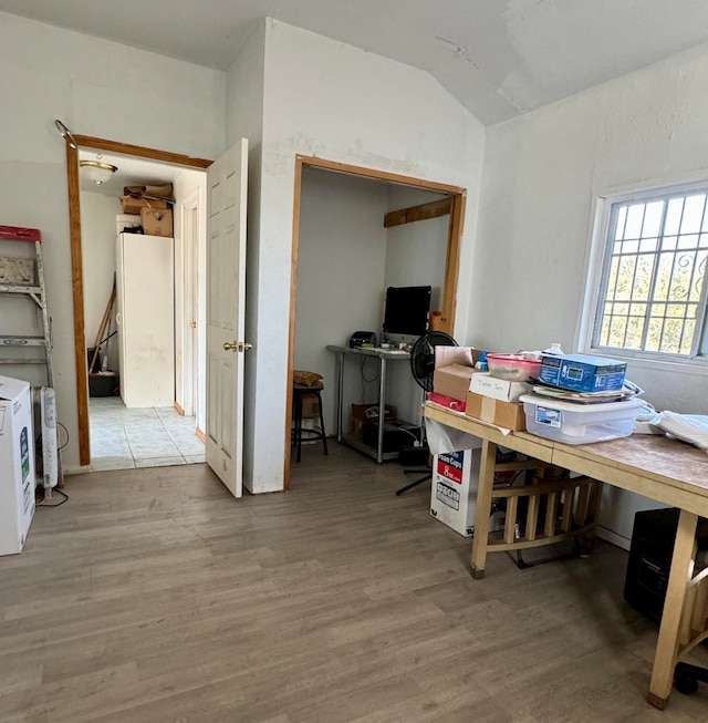 office featuring hardwood / wood-style flooring and vaulted ceiling