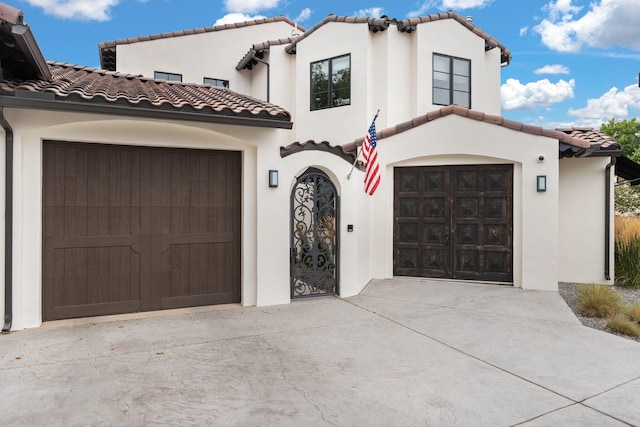 mediterranean / spanish-style home with a garage