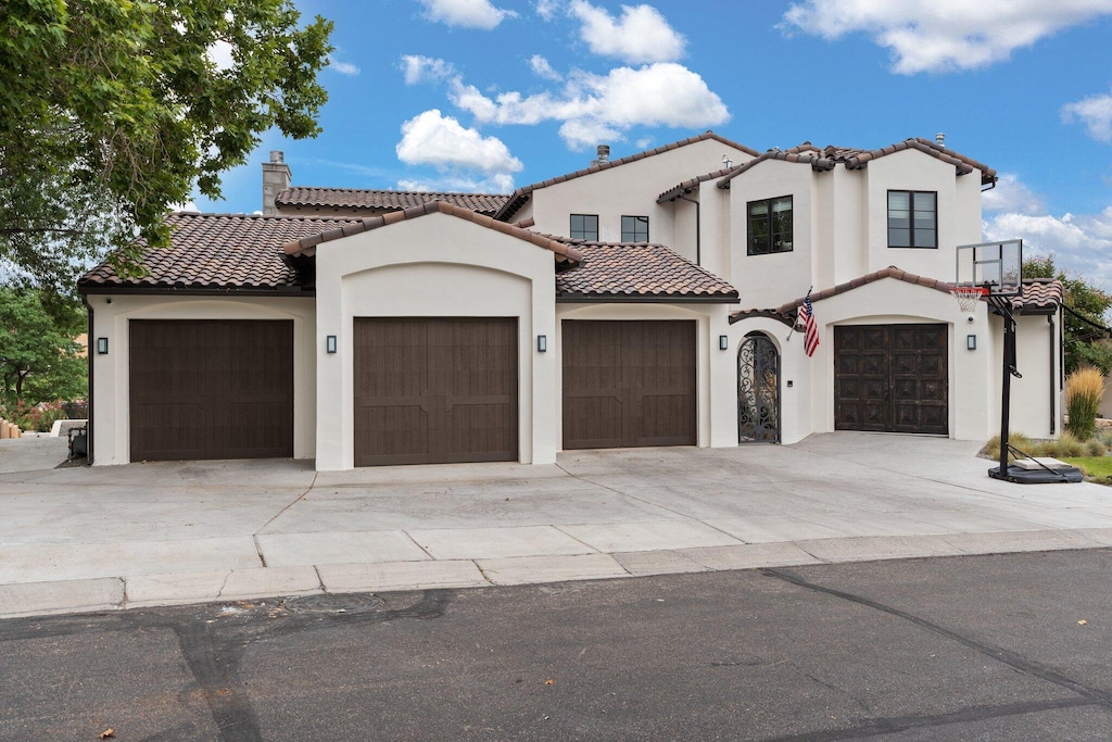 mediterranean / spanish home with a garage