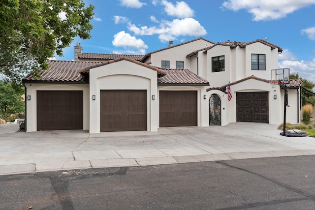 mediterranean / spanish home with a garage