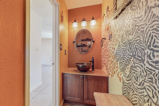 bathroom featuring tile flooring and vanity with extensive cabinet space