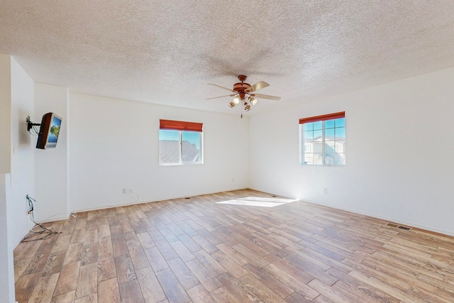 unfurnished room featuring light hardwood / wood-style floors, a textured ceiling, and ceiling fan