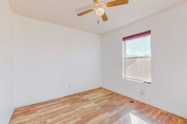 empty room with ceiling fan and light hardwood / wood-style flooring