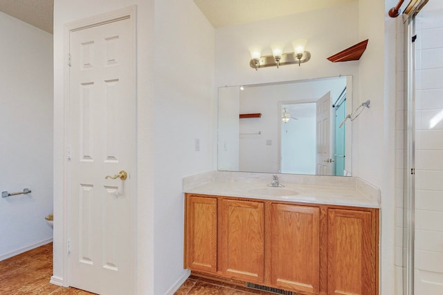 bathroom featuring ceiling fan, tile flooring, and vanity with extensive cabinet space