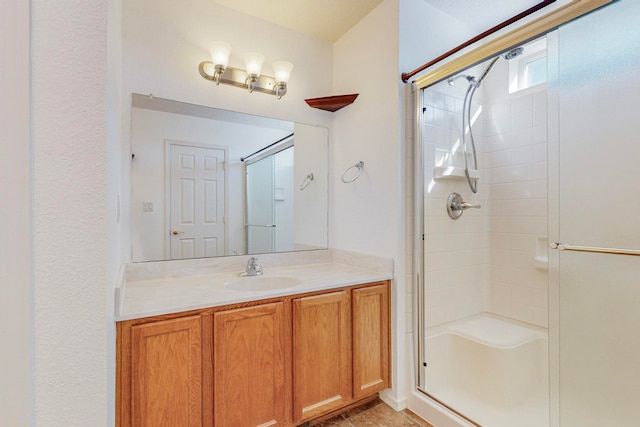 bathroom with tile floors, vanity, and a shower with shower door