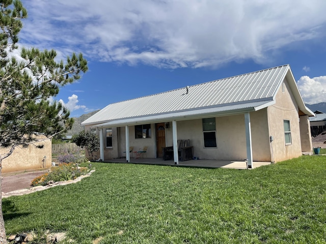 back of house featuring a yard and a patio