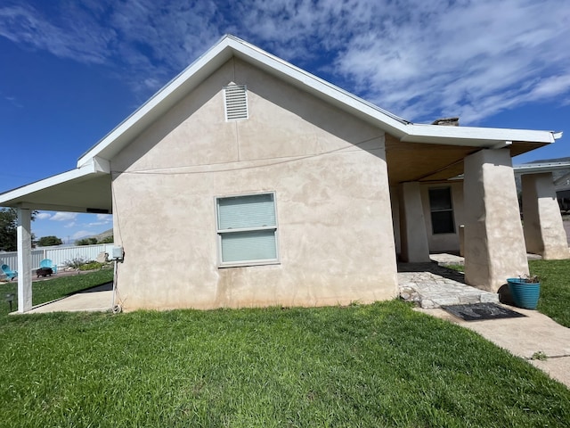 view of side of home featuring a lawn