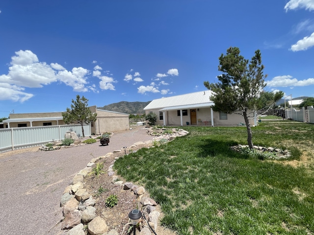 ranch-style house with a mountain view and a front lawn