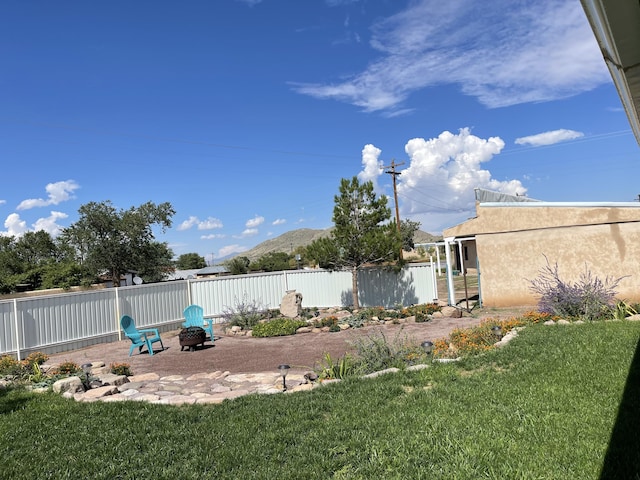 view of yard featuring a mountain view and a fire pit