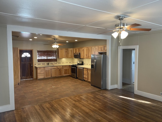 kitchen featuring stainless steel appliances, dark wood-type flooring, sink, and ceiling fan