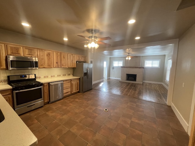 kitchen featuring tasteful backsplash, stainless steel appliances, and ceiling fan