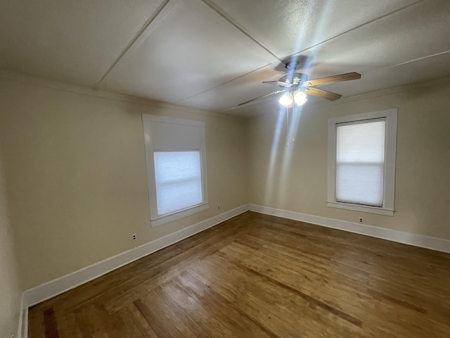 spare room featuring hardwood / wood-style flooring and ceiling fan