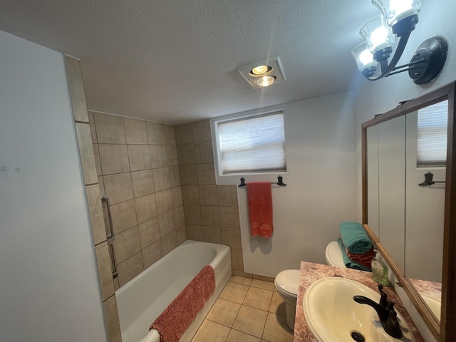 bathroom featuring tile patterned floors, toilet, sink, and a textured ceiling