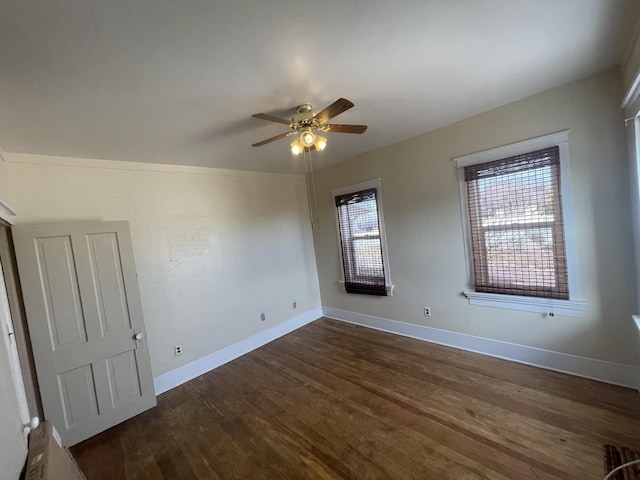 spare room with ceiling fan and dark hardwood / wood-style floors