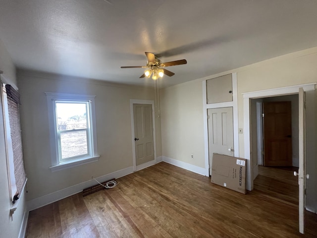 unfurnished bedroom with dark wood-type flooring and ceiling fan