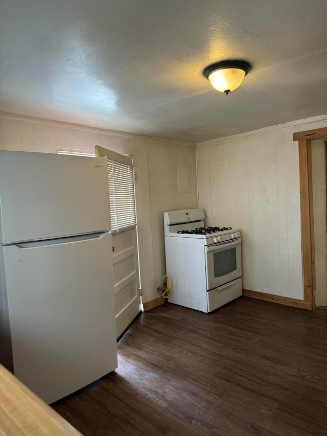 kitchen featuring a textured ceiling, dark hardwood / wood-style flooring, and white appliances