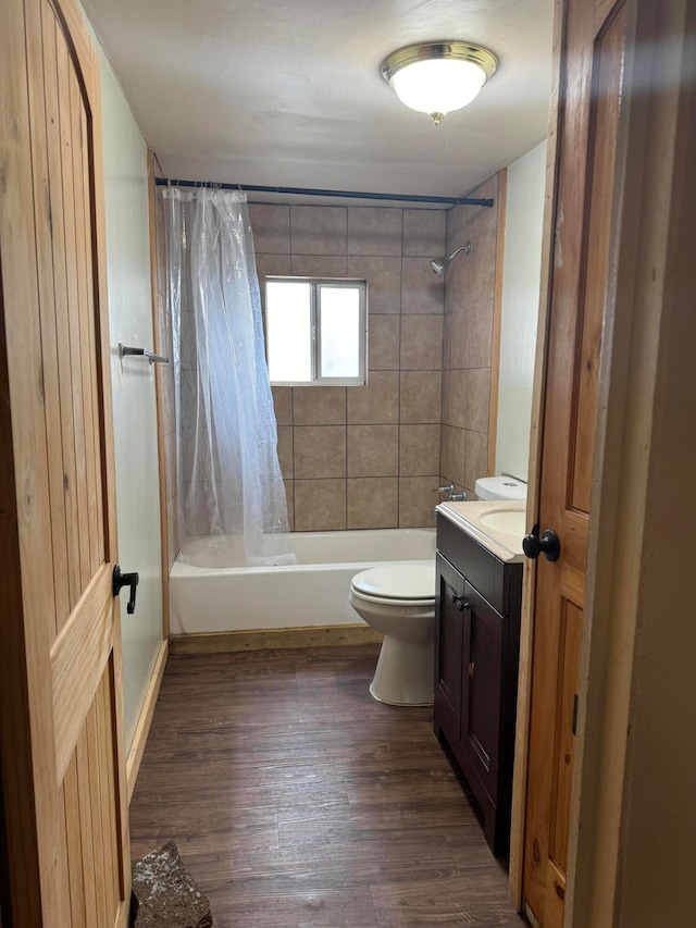 full bathroom featuring vanity, hardwood / wood-style flooring, toilet, and shower / bath combination with curtain