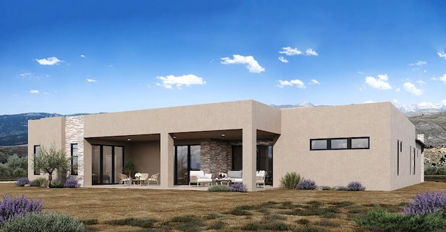 rear view of property featuring a patio area, a mountain view, and a yard