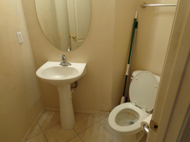 bathroom featuring tile patterned floors and toilet