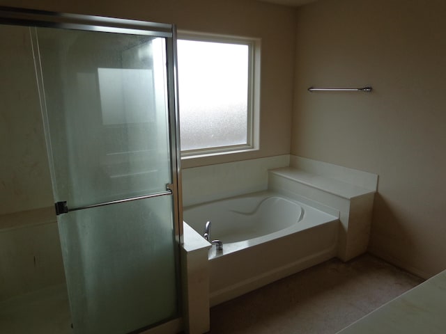 bathroom featuring separate shower and tub