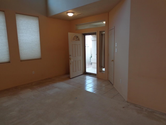 view of carpeted foyer entrance