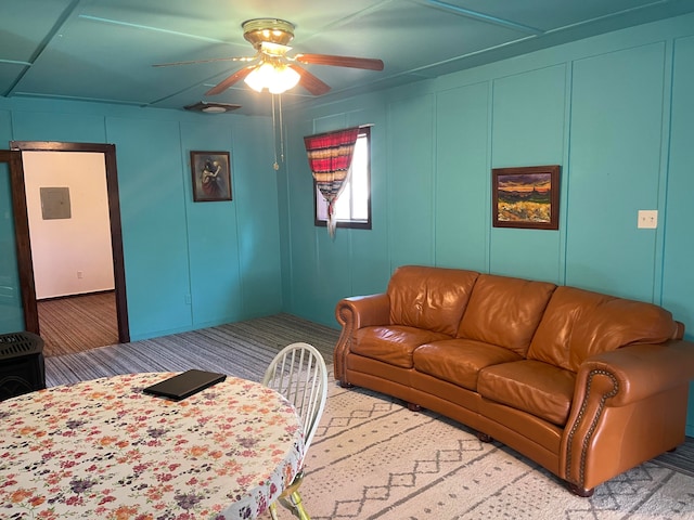 carpeted living room featuring ceiling fan