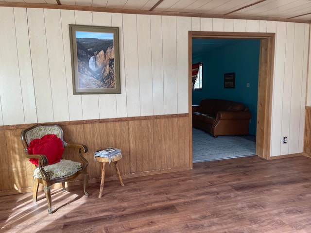 sitting room with wood ceiling, wood walls, and dark wood-type flooring