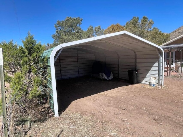 view of vehicle parking with a carport