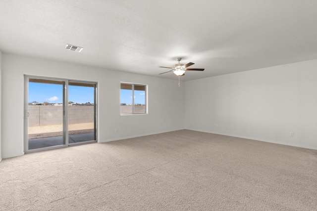 empty room with light colored carpet and ceiling fan