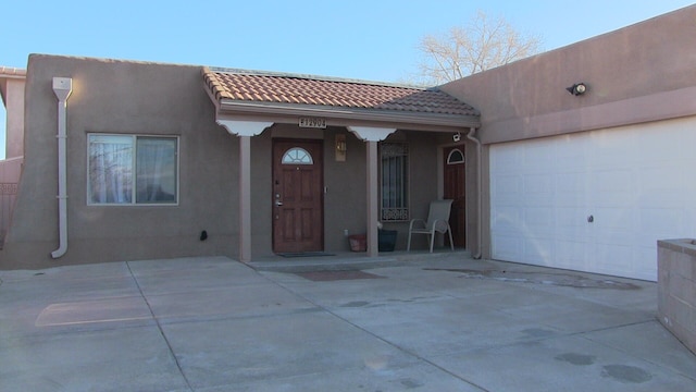 rear view of property with a garage