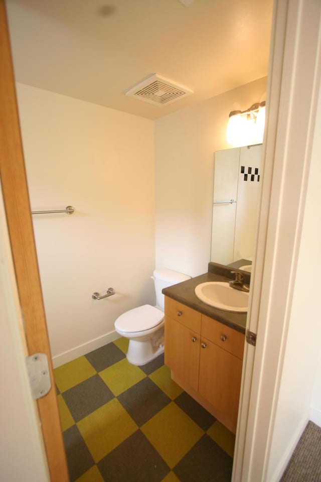 324 Broadway Blvd NE, Albuquerque, NM 87102 - half bath with vanity, tile patterned floors, and toilet