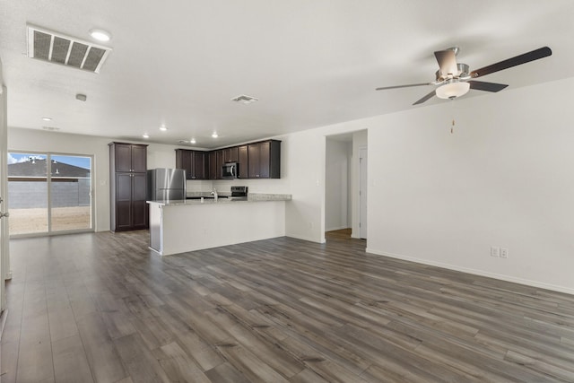 unfurnished living room with ceiling fan, sink, and dark hardwood / wood-style flooring