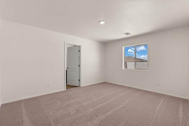 spare room featuring carpet flooring