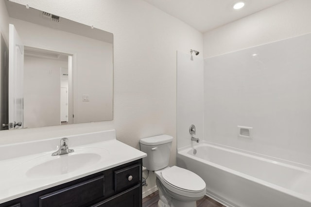 full bathroom with shower / washtub combination, hardwood / wood-style floors, vanity, and toilet