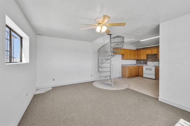 unfurnished living room with light carpet and ceiling fan