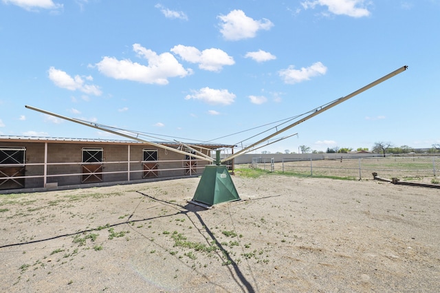 view of yard featuring an outdoor structure and a rural view