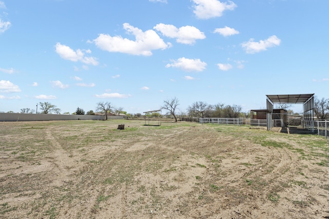 view of yard with a rural view and an outdoor structure