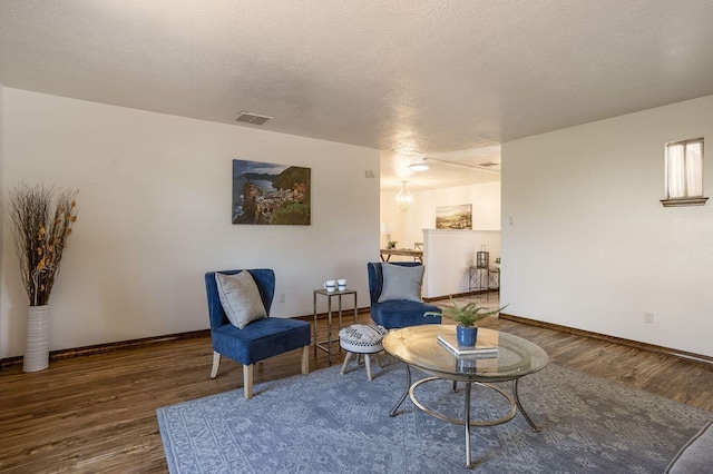 sitting room featuring wood-type flooring and a textured ceiling