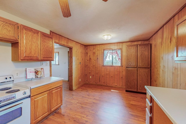 interior details with hardwood / wood-style flooring, a wood stove, and a textured ceiling