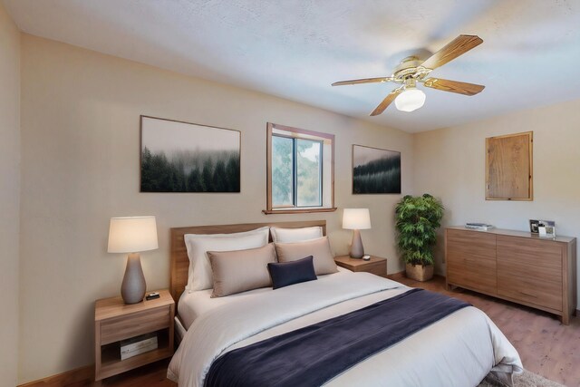 bedroom with ceiling fan and hardwood / wood-style floors