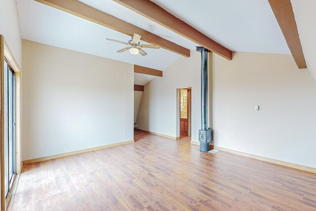 empty room with vaulted ceiling with beams, hardwood / wood-style floors, and ceiling fan