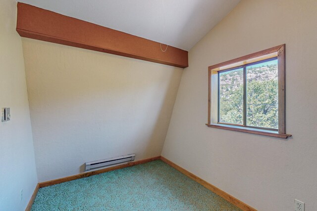 spare room with vaulted ceiling, a baseboard radiator, and carpet floors