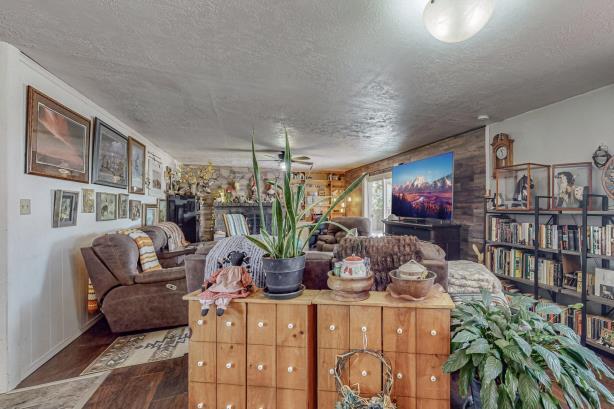 living room featuring wood-type flooring and a textured ceiling